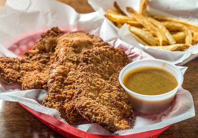 Crispy chicken tenders with fries and dipping sauce at WingBasket, Nashville. Order wings online for delivery.